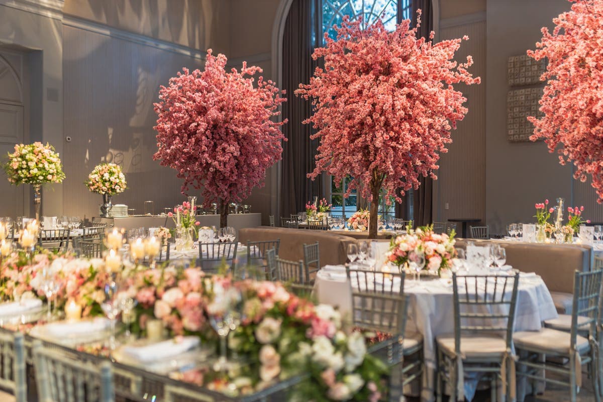 Elegant ballroom with formal table settings, floral centrepieces, and chiavari chairs for a gala dinner